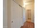 Hallway featuring wood-look flooring and access to multiple rooms, including closet space at 1825 E Sycamore Rd, Casa Grande, AZ 85122