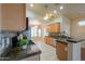 Open kitchen with wooden cabinets, granite countertops, stainless steel appliances, and tile floors at 1825 E Sycamore Rd, Casa Grande, AZ 85122