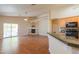 Bright, open-concept living area with a fireplace, hardwood floors, and sliding doors to the backyard patio at 1825 E Sycamore Rd, Casa Grande, AZ 85122