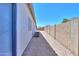 Exterior shot of a side yard featuring gravel landscaping, an AC unit, and a privacy wall at 1825 E Sycamore Rd, Casa Grande, AZ 85122