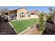 A well-maintained backyard features lush green grass and comfortable patio seating at 18665 N 70Th Dr, Glendale, AZ 85308