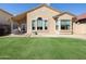 A well-maintained backyard features lush green grass and comfortable patio seating at 18665 N 70Th Dr, Glendale, AZ 85308