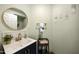 Stylish half bathroom features a vanity with a vessel sink, modern faucet, and decorative accents at 18665 N 70Th Dr, Glendale, AZ 85308