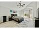 Spacious main bedroom features a vaulted ceiling, ceiling fan, and large windows at 18665 N 70Th Dr, Glendale, AZ 85308