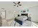 Bright primary bedroom with a large bed, ceiling fan, and decorative elements at 18665 N 70Th Dr, Glendale, AZ 85308