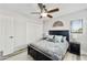 Comfortable bedroom with gray walls, wood-look floors, and a ceiling fan at 18665 N 70Th Dr, Glendale, AZ 85308