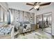 Well-decorated Bedroom with birch tree wallpaper, wooden floors, and plenty of natural light at 18665 N 70Th Dr, Glendale, AZ 85308