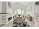 Elegant dining area featuring a fireplace, vaulted ceilings, and a large dining table, perfect for gatherings at 18665 N 70Th Dr, Glendale, AZ 85308