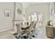 Bright dining room with vaulted ceilings, featuring a large dining table and stylish decor, creating an inviting atmosphere at 18665 N 70Th Dr, Glendale, AZ 85308