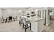 A modern kitchen with white cabinets, stainless steel appliances, and a central island with barstool seating at 18665 N 70Th Dr, Glendale, AZ 85308