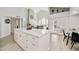 Open kitchen view features a marble countertop island with seating and modern finishes at 18665 N 70Th Dr, Glendale, AZ 85308