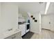 Laundry room with modern washer and dryer, utility sink, and ample storage space at 18665 N 70Th Dr, Glendale, AZ 85308