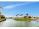 Scenic pond with a small island and mature trees, perfect for outdoor recreation at 18665 N 70Th Dr, Glendale, AZ 85308