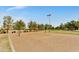 Outdoor sand volleyball court in a lush community sports park on a sunny day at 18665 N 70Th Dr, Glendale, AZ 85308