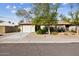Charming single-story home featuring a well-maintained front yard with desert landscaping and mature trees at 20602 N 31St Dr, Phoenix, AZ 85027