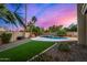 Backyard features a pool, artificial turf, and desert landscaping at 21 W Pecan Pl, Tempe, AZ 85284