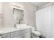 Bright bathroom featuring a modern sink, quartz countertops, and shower with white curtain at 21 W Pecan Pl, Tempe, AZ 85284