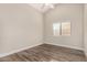 This bedroom features a ceiling fan, window with blinds, and wood-look flooring at 21 W Pecan Pl, Tempe, AZ 85284