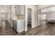 Hallway with wood-look floors, a built-in serving area, and views into a bathroom and bedroom at 21 W Pecan Pl, Tempe, AZ 85284