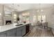 Kitchen with island, seamless flow to living and dining spaces, fireplace, and outdoor views create an inviting space at 21 W Pecan Pl, Tempe, AZ 85284