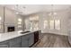 Open-concept kitchen with an island and adjacent fireplace, seamlessly flowing into the dining and living areas at 21 W Pecan Pl, Tempe, AZ 85284