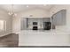 Bright kitchen features gray cabinets, black appliances, a modern backsplash, and a center island with white countertop at 21 W Pecan Pl, Tempe, AZ 85284