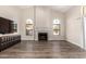 Bright living room boasts a fireplace, arched windows, and wood-style flooring, creating a welcoming space at 21 W Pecan Pl, Tempe, AZ 85284