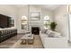 Relaxing living room features a fireplace, arched windows, and stylish decor, offering a comfortable atmosphere at 21 W Pecan Pl, Tempe, AZ 85284