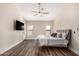 Bright main bedroom featuring a ceiling fan, two windows and hardwood floors at 21 W Pecan Pl, Tempe, AZ 85284