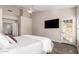 Bright main bedroom featuring a ceiling fan, TV, access to backyard and hardwood floors at 21 W Pecan Pl, Tempe, AZ 85284