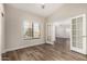 Bright office with wood-look floors, window with blinds, and double doors at 21 W Pecan Pl, Tempe, AZ 85284