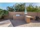 Outdoor kitchen features a built-in grill and bar seating, perfect for entertaining in style while enjoying the outdoors at 21 W Pecan Pl, Tempe, AZ 85284