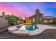 Inviting pool with rock landscaping and a covered patio, perfect for outdoor entertaining under colorful skies at 21 W Pecan Pl, Tempe, AZ 85284