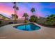 This backyard features a pool, patio, and lush landscaping with palm trees at 21 W Pecan Pl, Tempe, AZ 85284