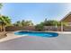 Inviting backyard pool with outdoor kitchen, spacious deck, and privacy landscaping perfect for relaxing and entertaining at 21 W Pecan Pl, Tempe, AZ 85284