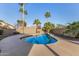 Inviting pool area features a baja step entry, mature palm trees and spacious deck perfect for outdoor entertaining at 21 W Pecan Pl, Tempe, AZ 85284