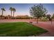 Picturesque view of the golf course community, featuring manicured greens and palm trees at 23116 N Del Monte Dr, Sun City West, AZ 85375