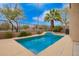 Backyard featuring a swimming pool with a desert landscape and palm trees surrounding the area at 24306 N 27Th Pl, Phoenix, AZ 85024