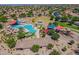 Aerial view of a resort-style community pool, playgrounds, picnic area, and grassy fields at 2524 E Katrina Trl, Casa Grande, AZ 85194