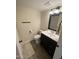 Compact half bath featuring a black vanity with a white countertop and neutral walls at 2634 E Fountain St, Mesa, AZ 85213