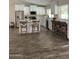 Bright and open kitchen features wood-look tile flooring, white cabinetry, and stainless steel appliances at 2634 E Fountain St, Mesa, AZ 85213