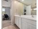 Bathroom featuring a double sink vanity with a large mirror and white cabinets at 2753 S 85Th Way, Mesa, AZ 85209