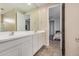 Primary bathroom with double sinks, tile floors and views into the primary bedroom at 2753 S 85Th Way, Mesa, AZ 85209