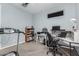 Spare bedroom featuring a treadmill, ceiling fan, and a desk area with natural lighting at 2753 S 85Th Way, Mesa, AZ 85209