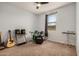Bedroom with carpet floors, window, ceiling fan and musical instruments at 2753 S 85Th Way, Mesa, AZ 85209