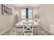 Dining room showcasing a large white table, upholstered seating, and natural light at 2753 S 85Th Way, Mesa, AZ 85209