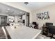 Bright dining room with large table adjacent to a modern, well-equipped kitchen and guitar wall art at 2753 S 85Th Way, Mesa, AZ 85209