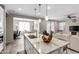 Modern kitchen features a granite island, pendant lighting, and stainless steel sink at 2753 S 85Th Way, Mesa, AZ 85209