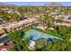 The aerial captures the scenic beauty of a charming neighborhood with mature trees and tennis courts at 2910 E Avenida Olivos --, Phoenix, AZ 85016