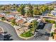 Scenic aerial view of the property featuring red tiled roofs, mature trees, and views of the city and mountains at 2910 E Avenida Olivos --, Phoenix, AZ 85016